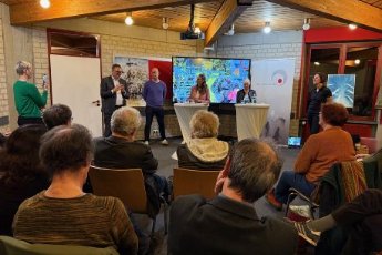 Blick auf das Publikum und die Teilnemenden der Podiumsdiskussion